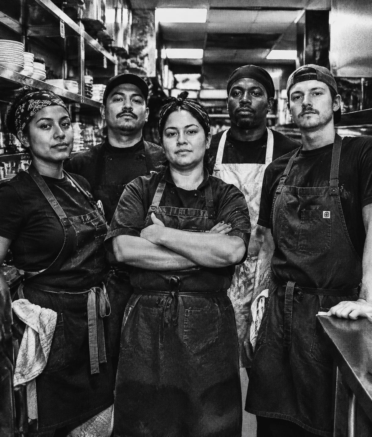 Illinois service workers standing together in a restaurant kitchen